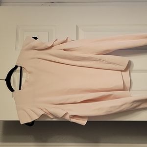 Club Monica sweater with open shoulders that are ruffled.